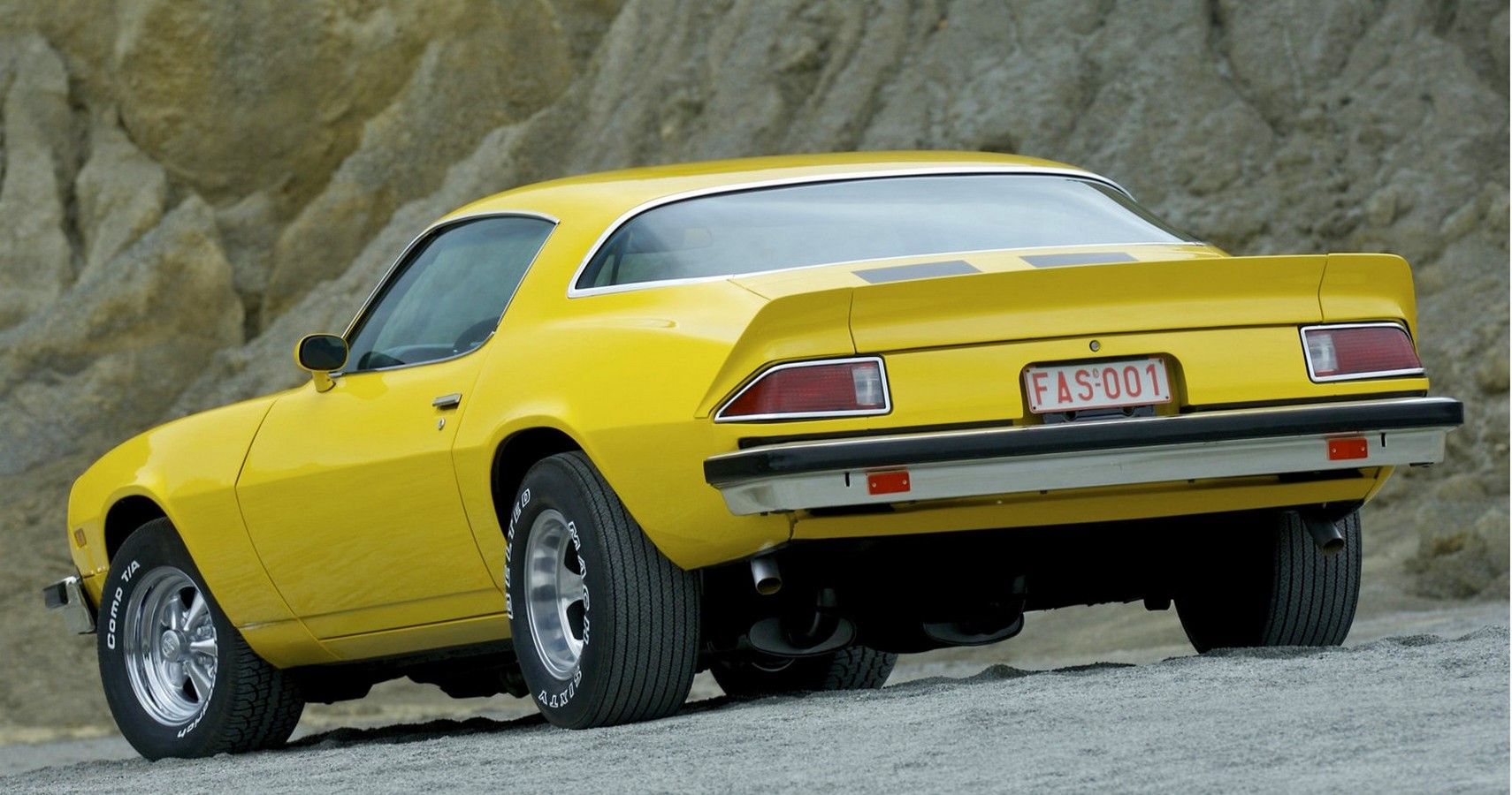 Yellow 1975 Chevrolet Camaro Parked Outside