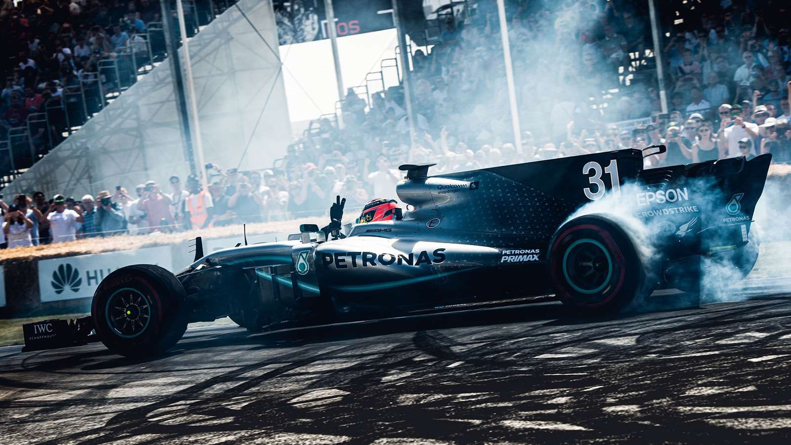 An F1 car does donuts at the Festival of Speed
