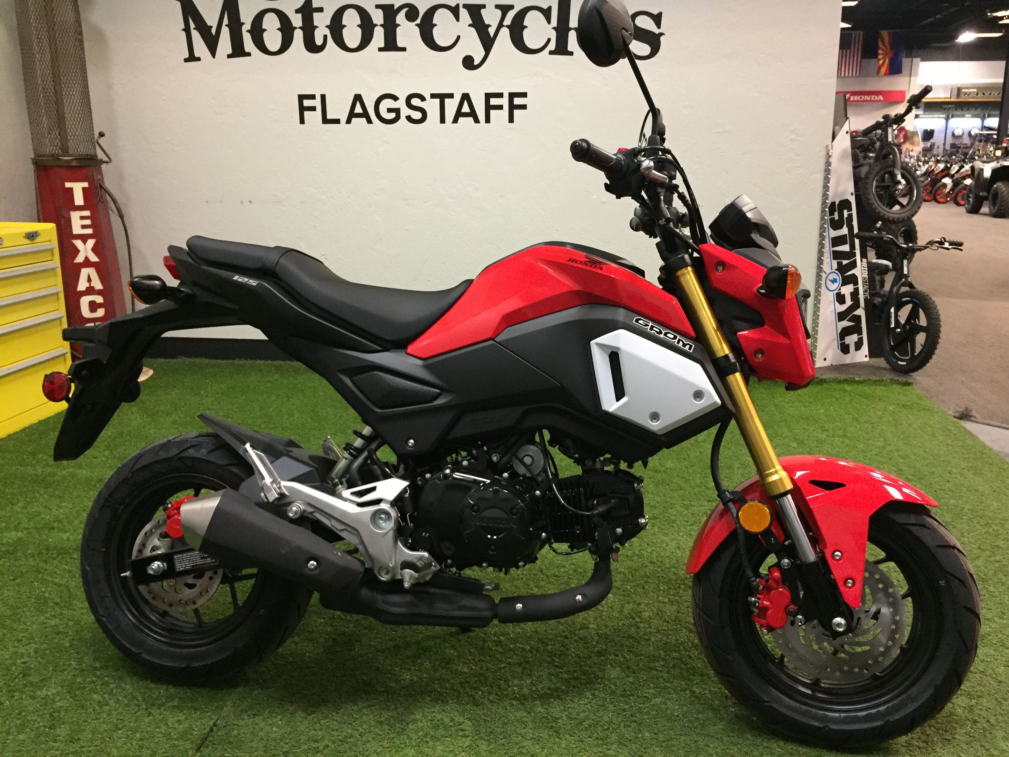 Red Honda Grom parked indoors