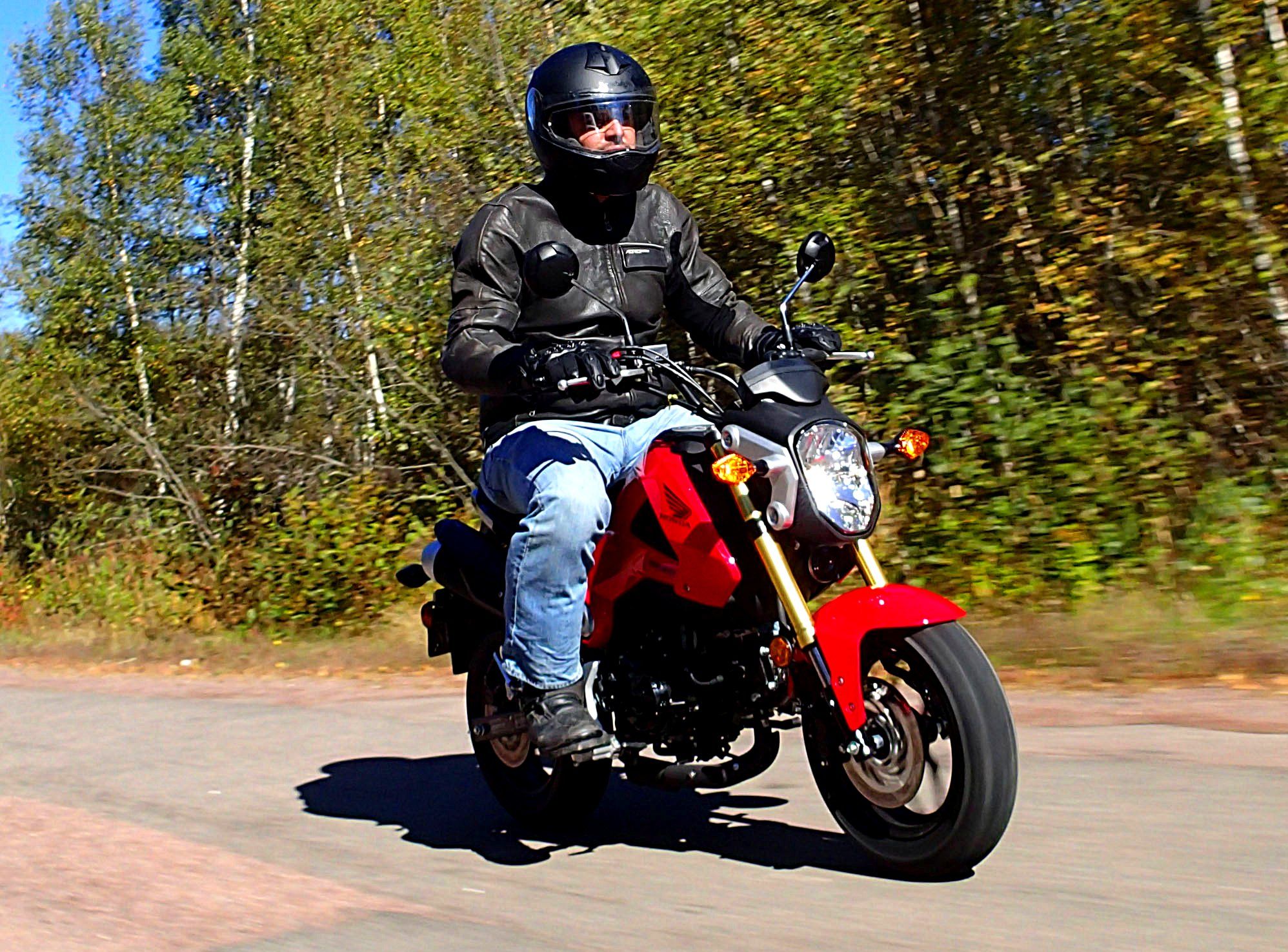 Man riding red Honda Grom