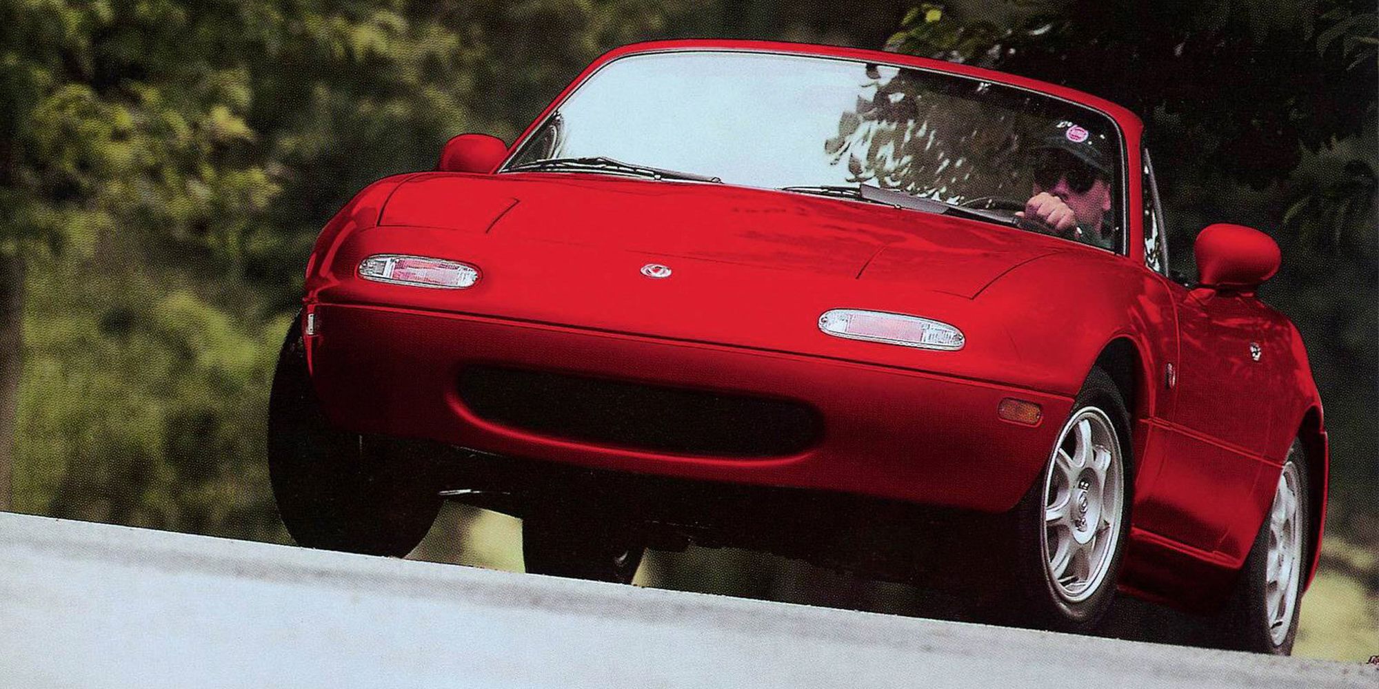 The front of a red NA Miata