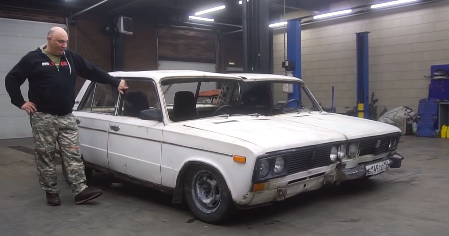 Mechanic from Garage 54 poses with two Ladas welded together