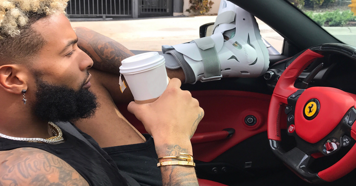 odell became driving with moon boot drinking coffee in Ferrari