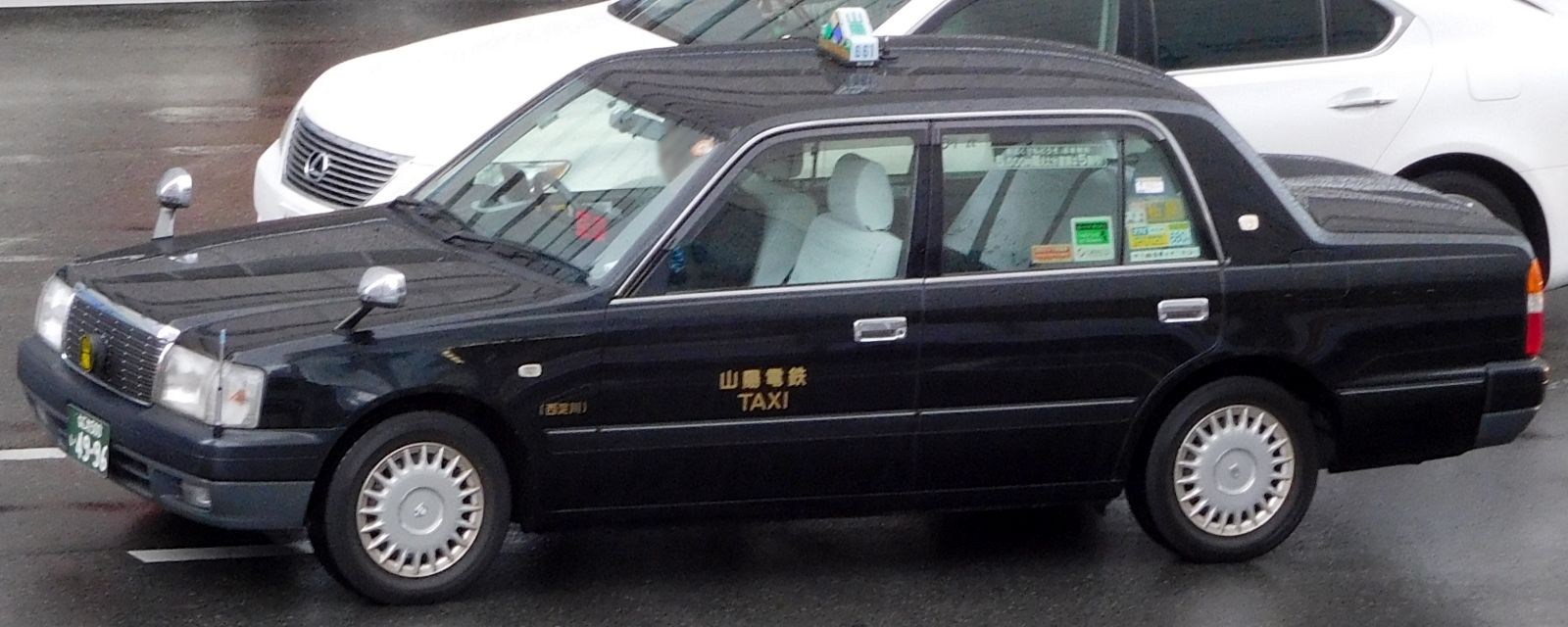 This Toyota Crown Comfort is equipped with fender mirrors.