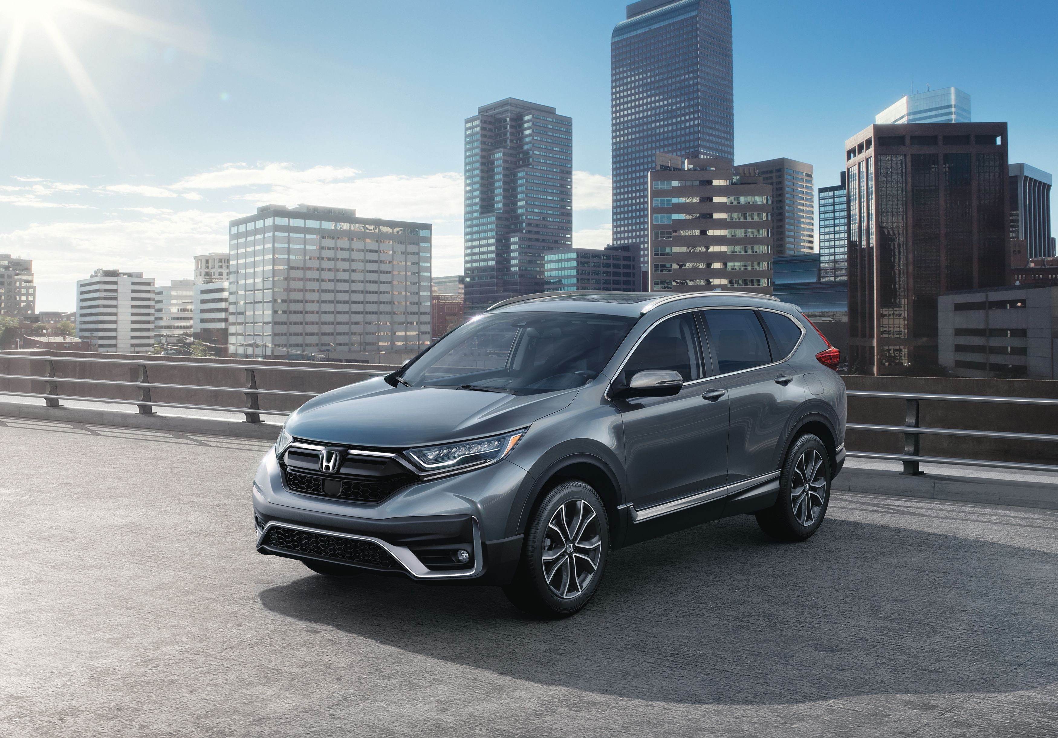 2020 Honda CR-V Touring in silver with a city skyline