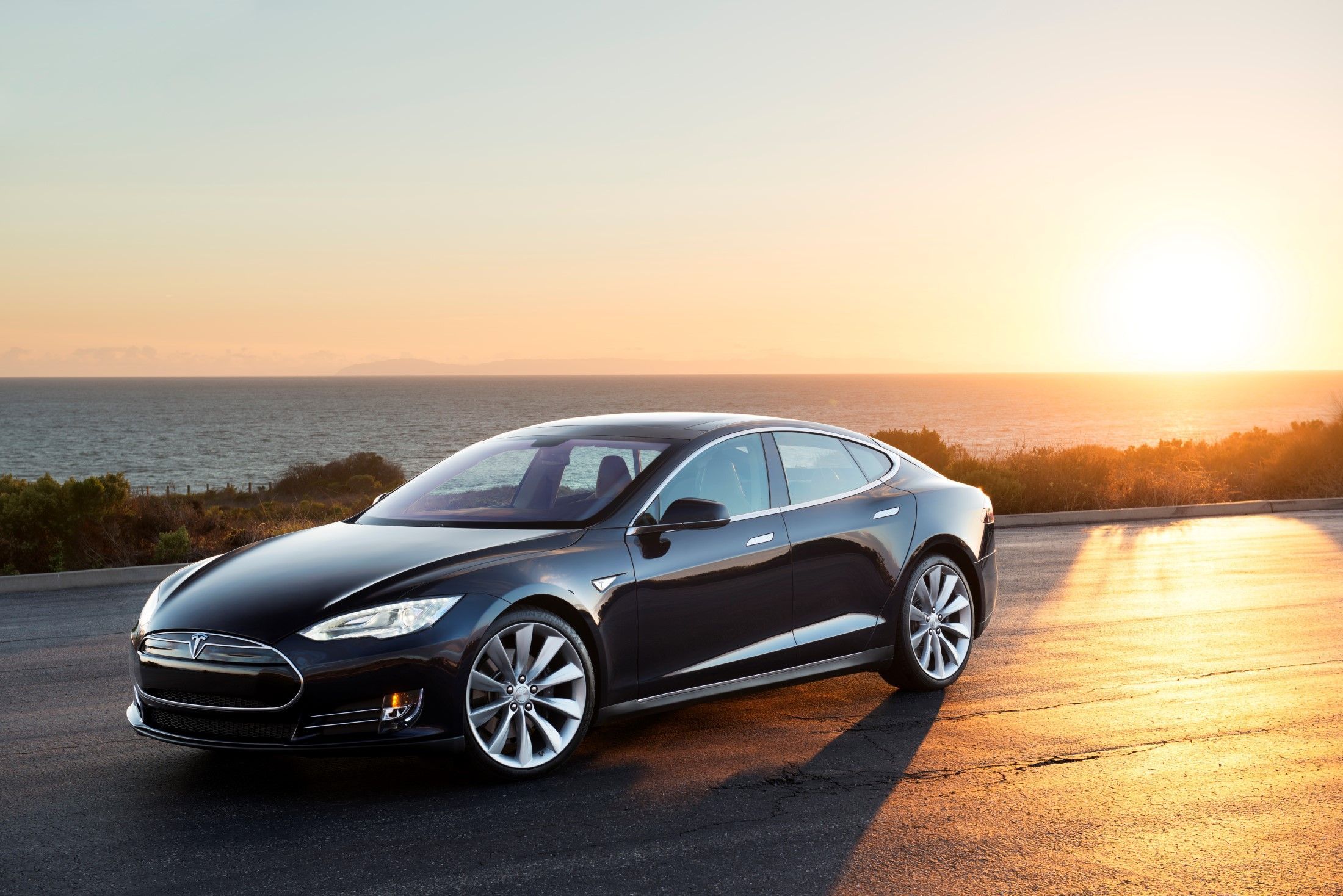 Black 2012 Tesla Model S Parked With An Ocean View