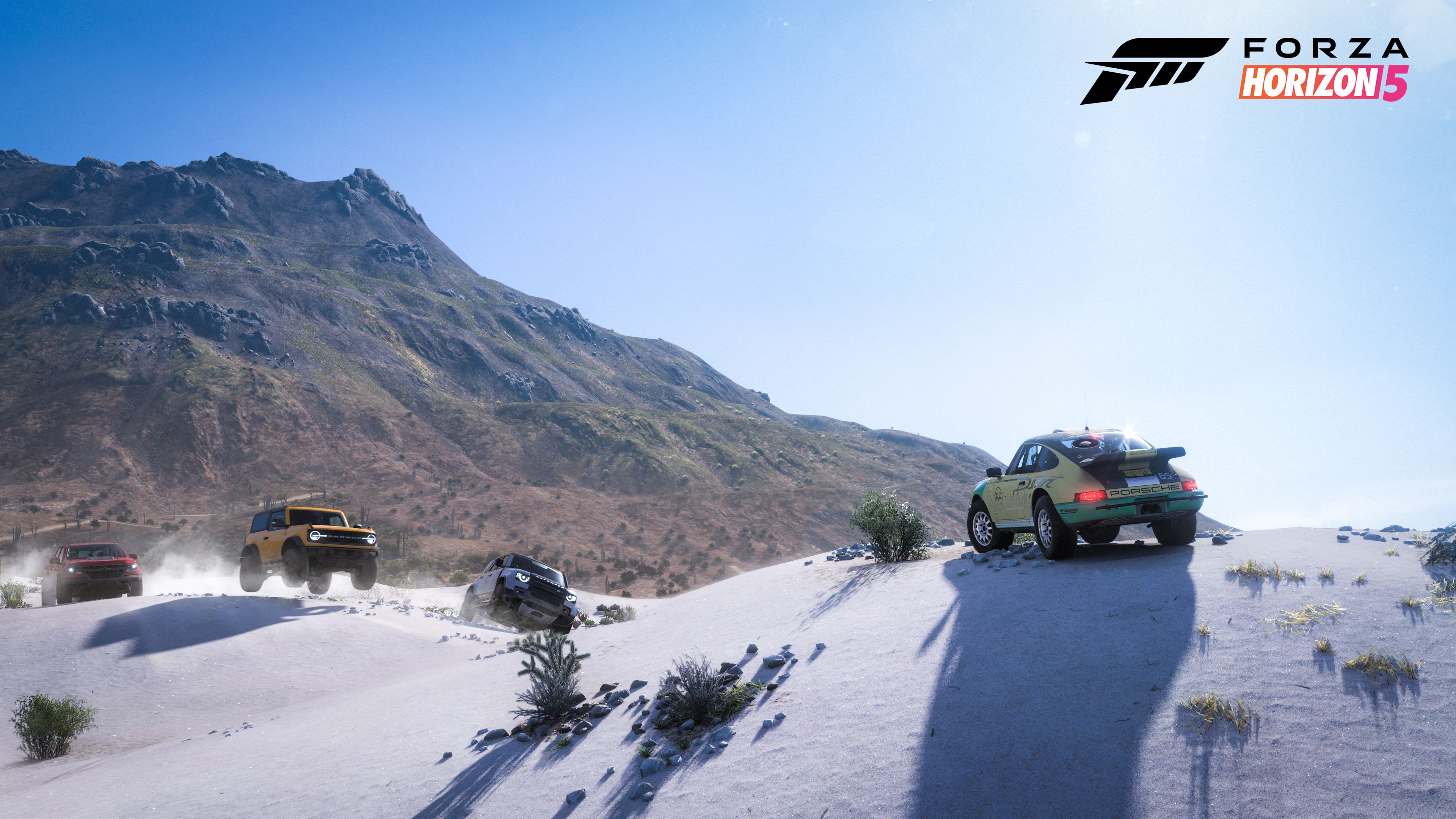 A bunch of vehicles on top of a mountain in Forza Horizon 5
