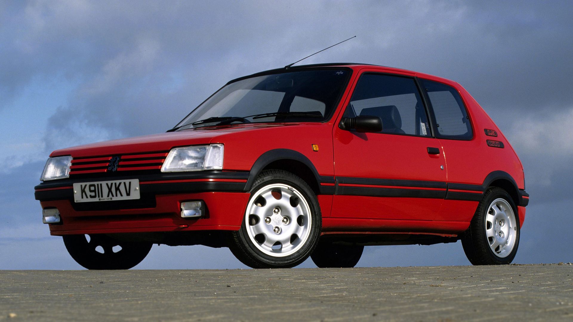 Front 3/4 view of a red 205 GTI