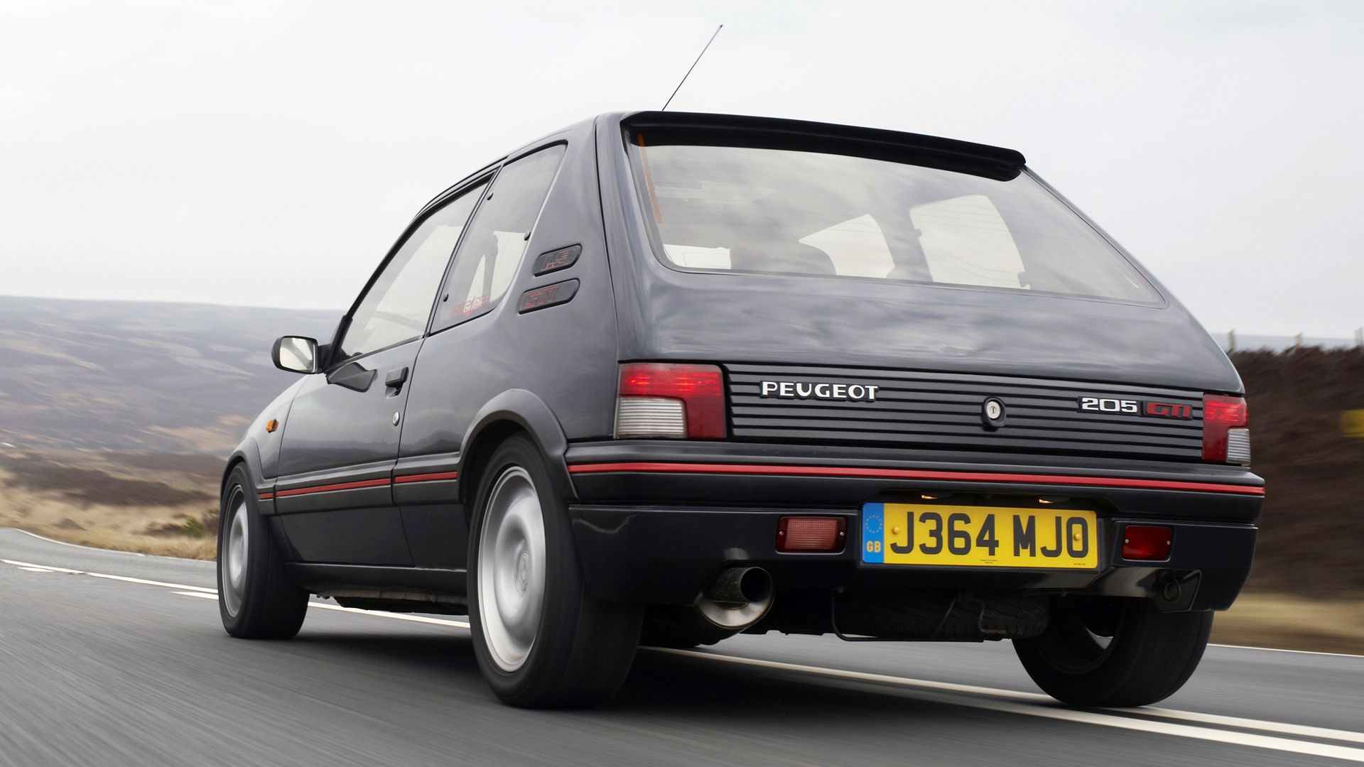 The rear of a 205 GTI on the move
