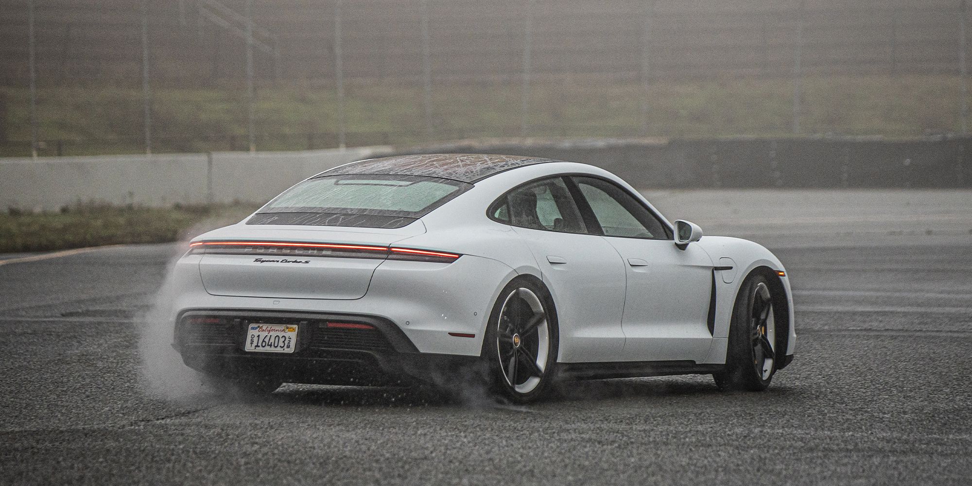 The rear of a drifting Taycan Turbo S