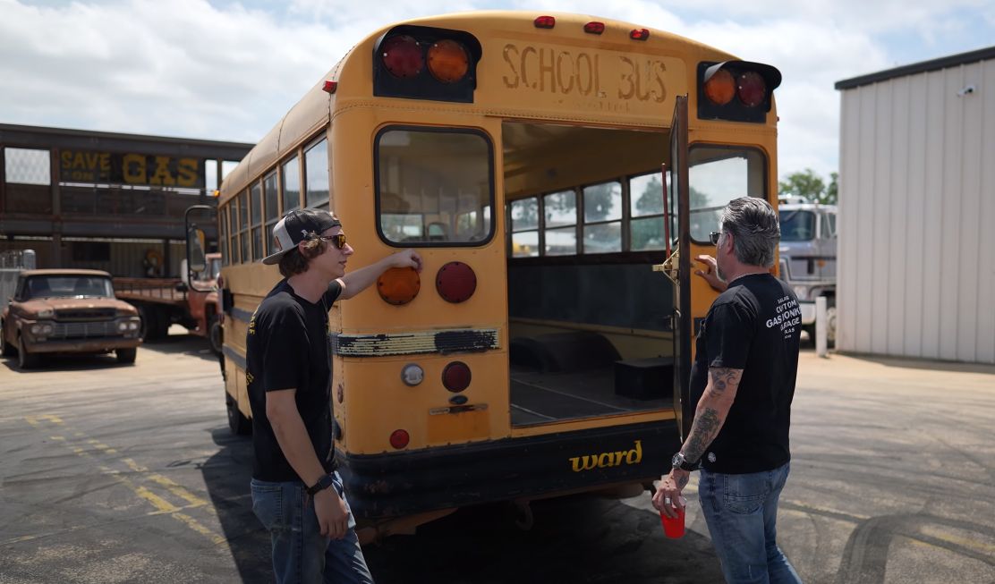 Schoolbus rear being examined by Gas Monkey Garage crew