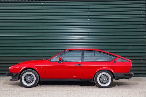 An Image Of A Red Alfa Romeo GTV6 3.0
