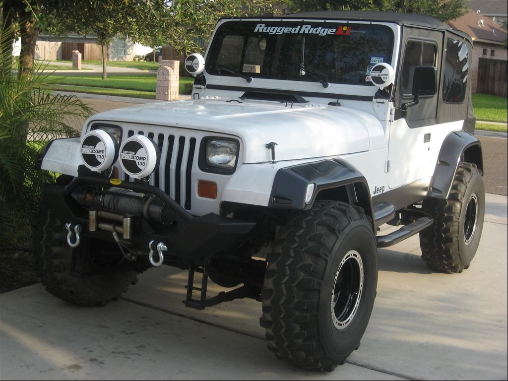 White Jeep Wrangler YJ parked in driveway