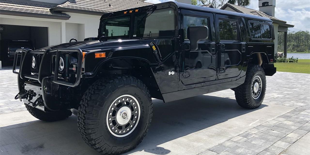 Black Hummer H1 parked in the driveway