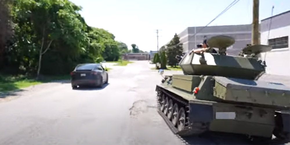 CVRT military vehicle pursues a Tesla Model X in a drag race