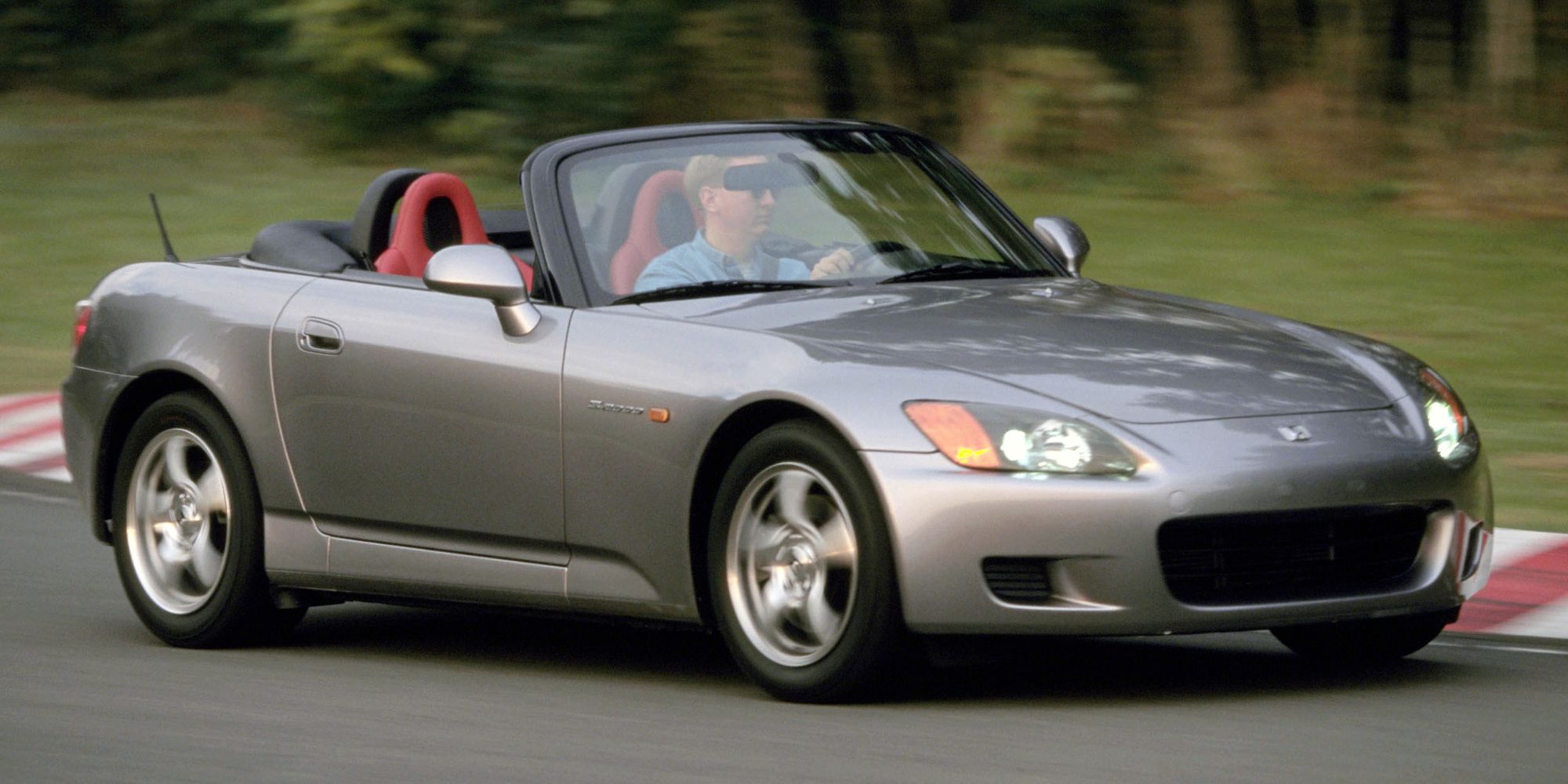 A silver S2000 on track