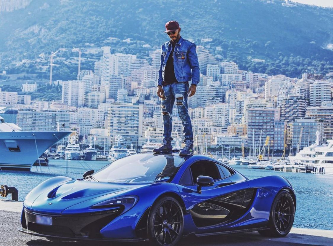 Hamilton posing on top of his Blue McLaren P1