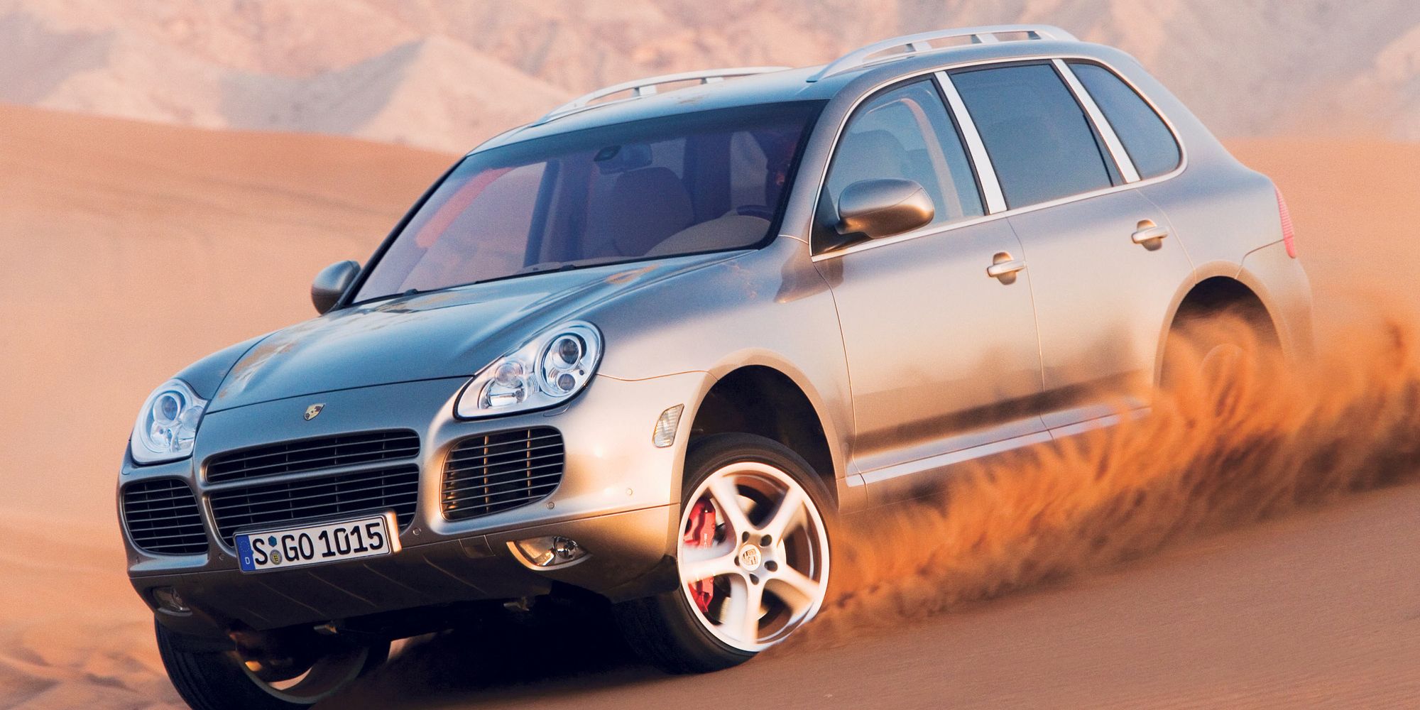 Front 3/4 view of the Cayenne Turbo blasting through the sand