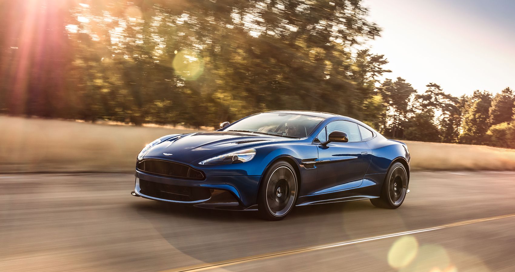 Blue Aston Martin Vanquish S Driving