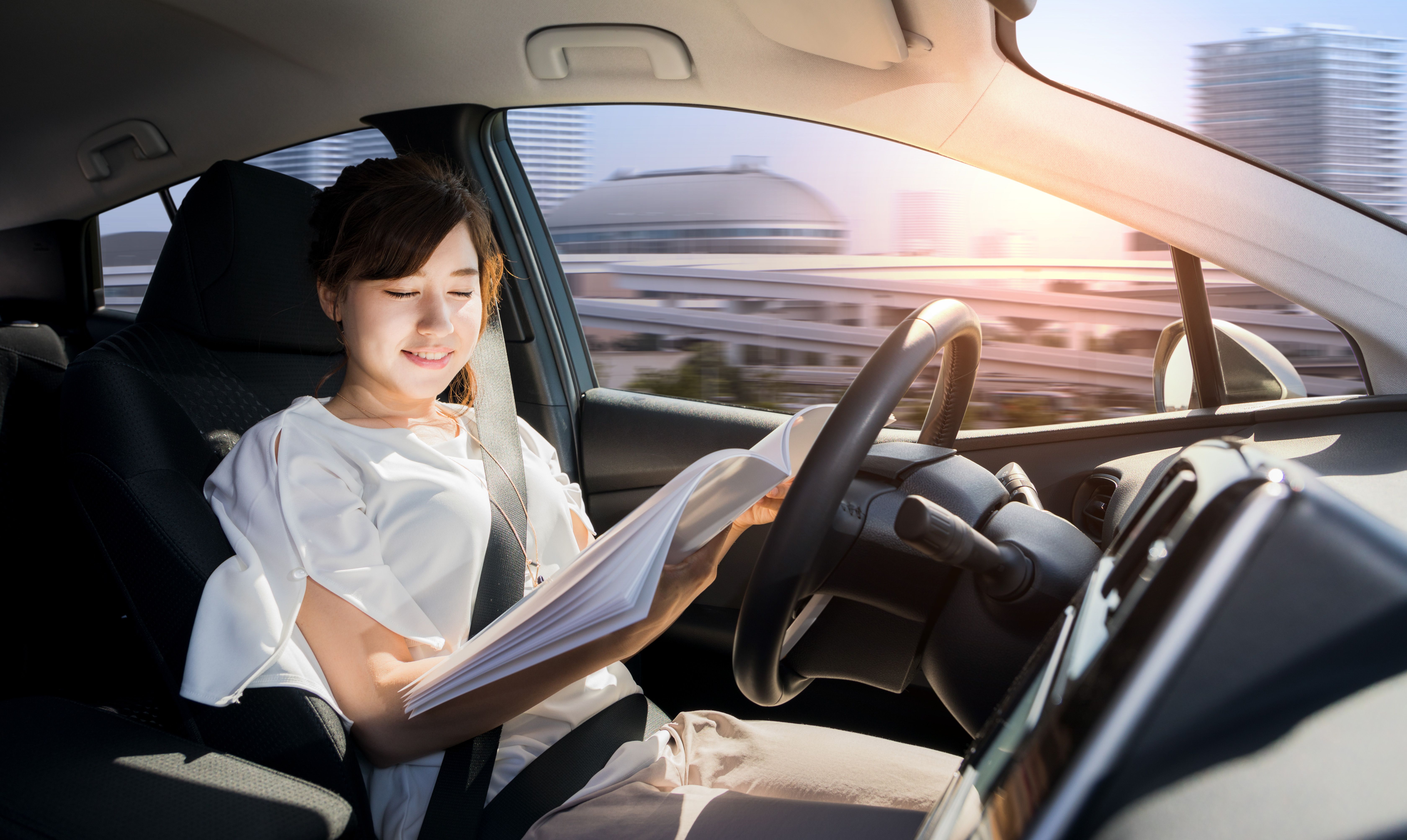 Woman Reads In Autonomous Car