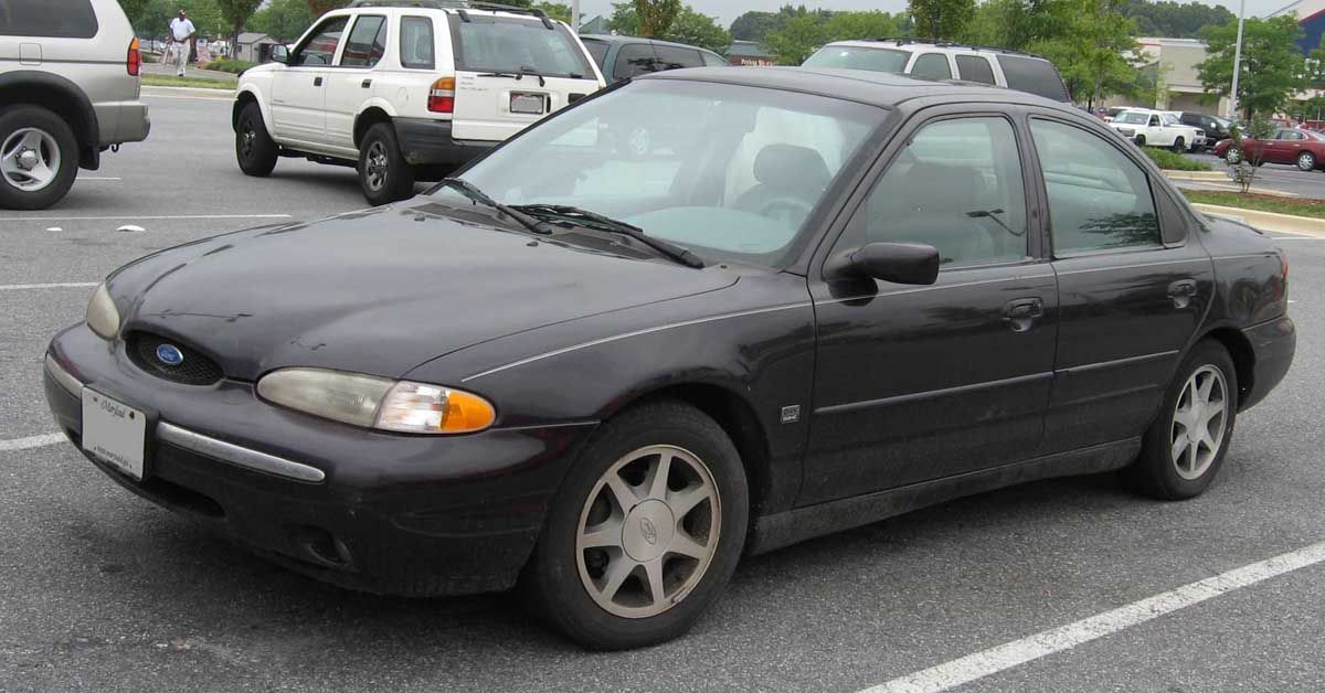 Black 1995 Ford Contour: Parked outside