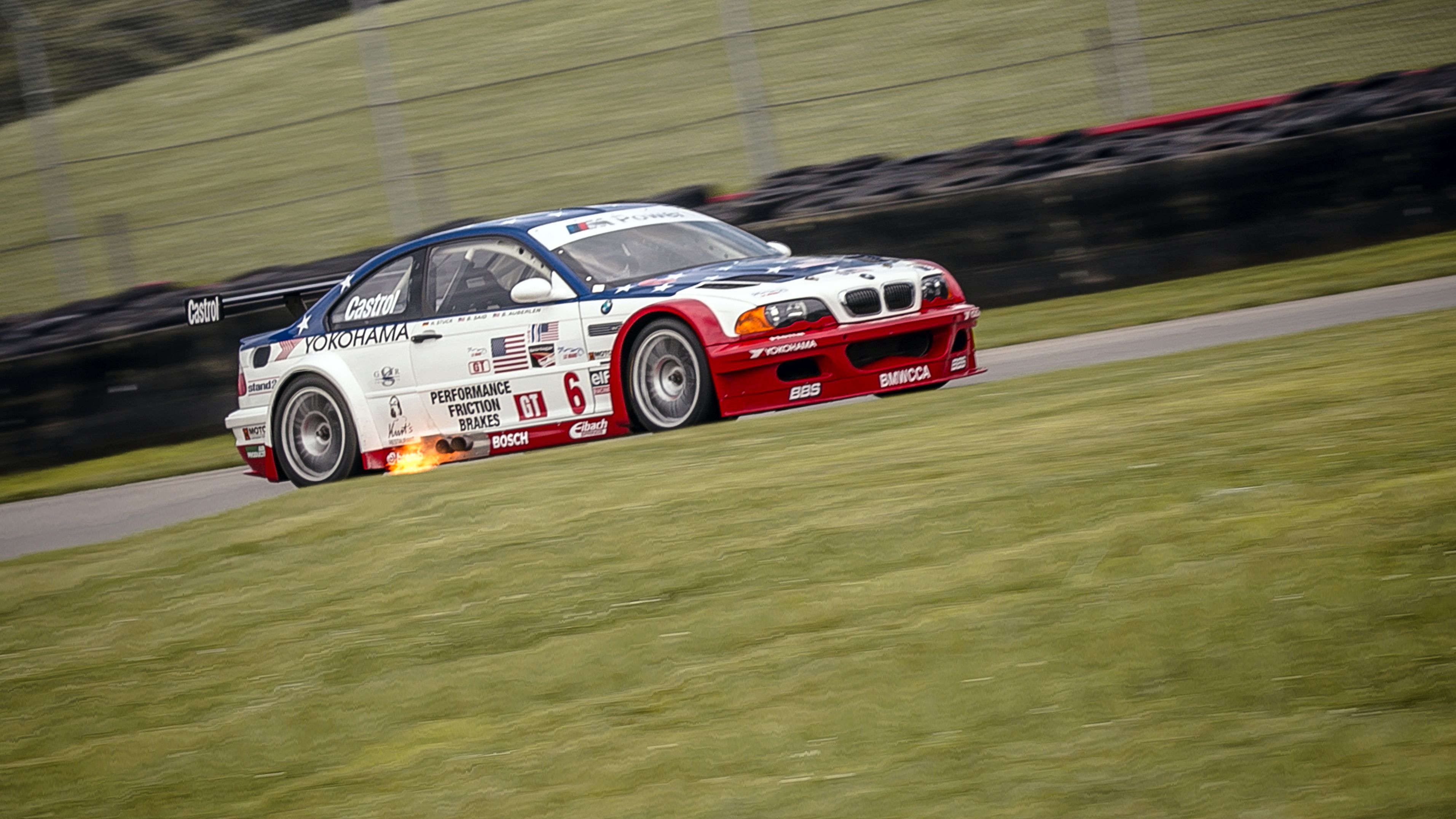 2001 M3 GTR racing on track with grass around it