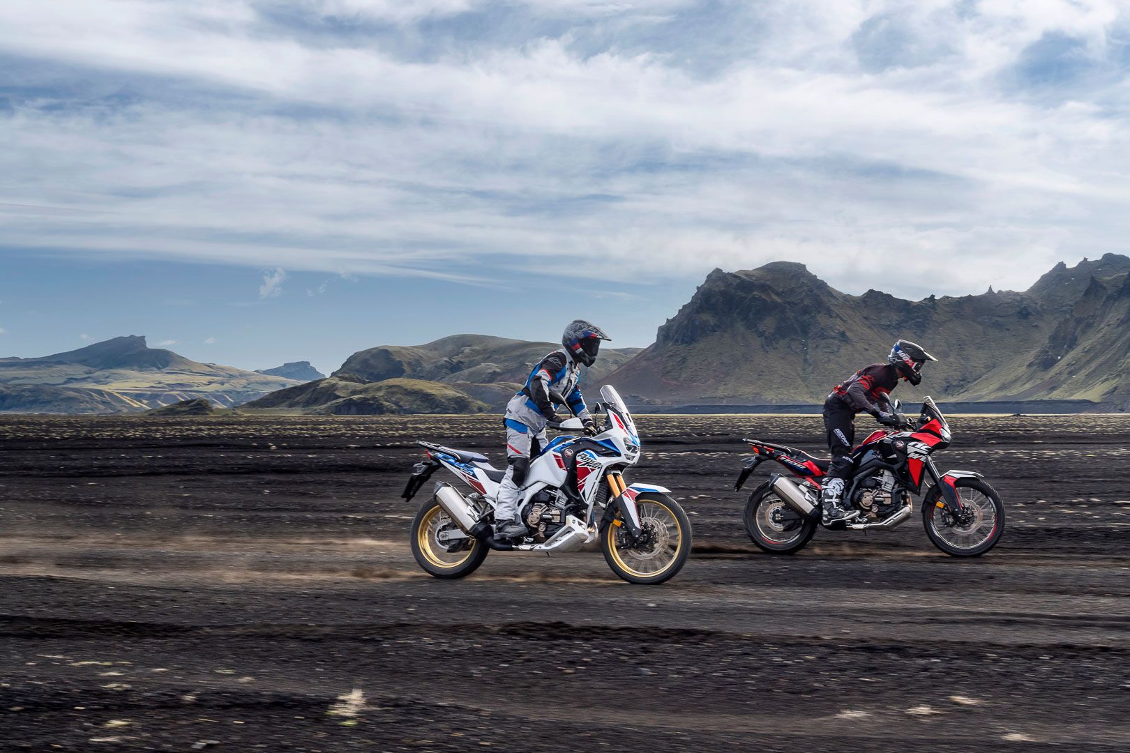 Two riders racing 2022 Honda Africa Twin models in dirt