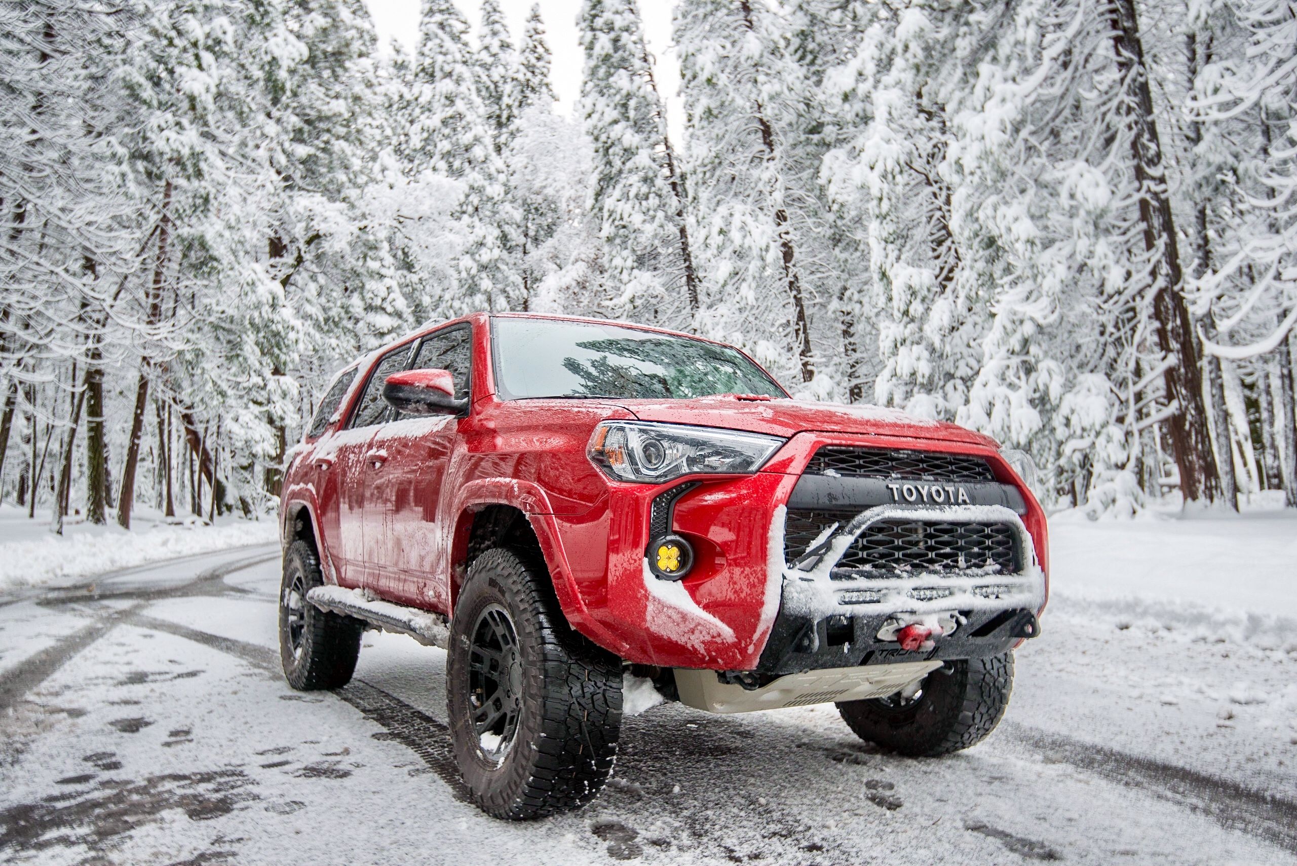 Red TRD Pro 4runner in the snow front yellow fog lights mod 2019 2020 2021 2022