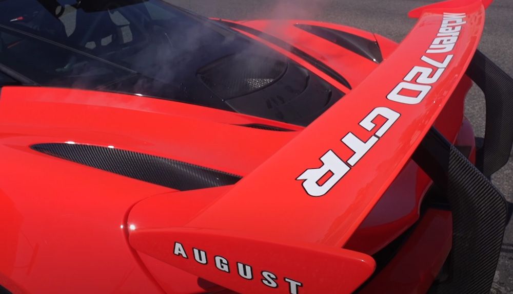 Smoke pours out from rear of Orange McLaren 720 GTR