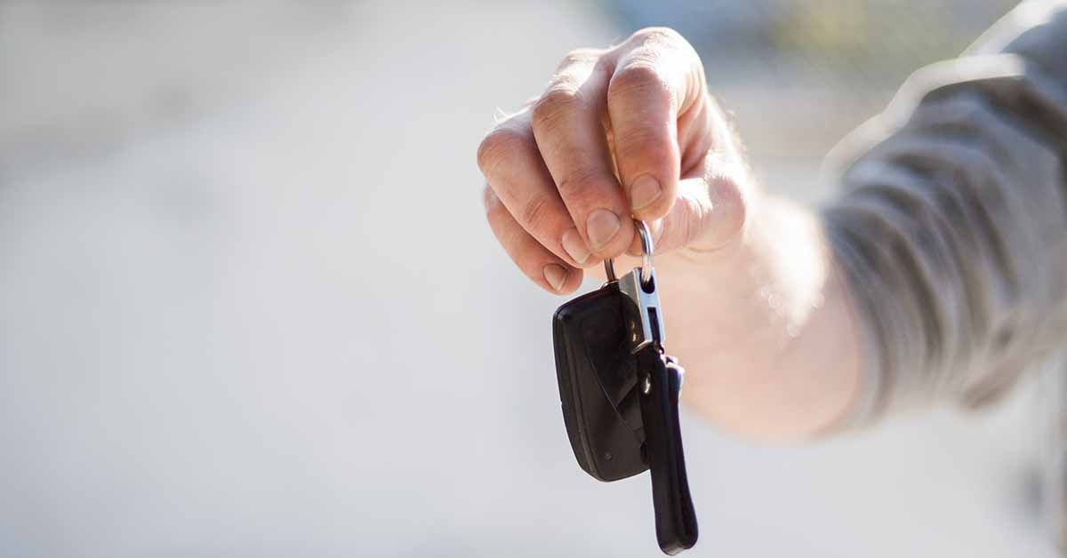 Person Holding Car Keys