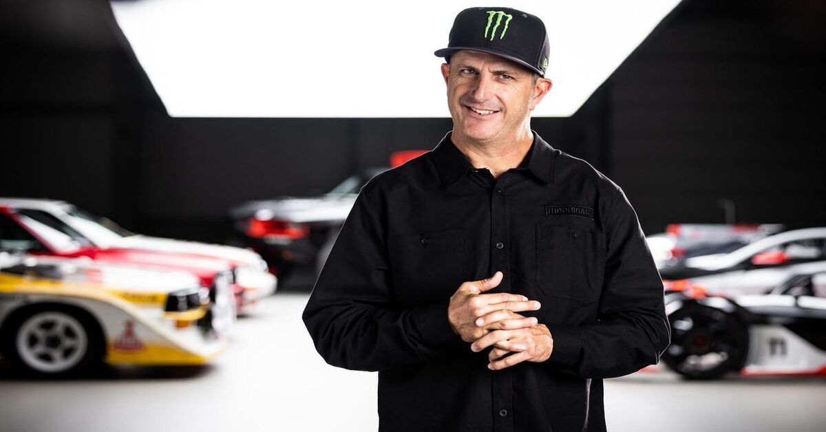 ken block stands in front of rally cars