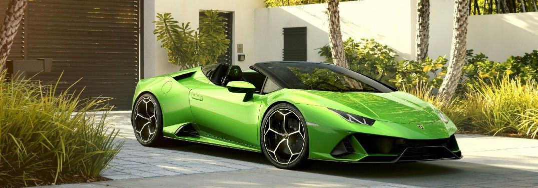 2020-Lamborghini-huracan-EVO-Spyder-green-exterior-parked-in-front-of-wall-and-gate_o
