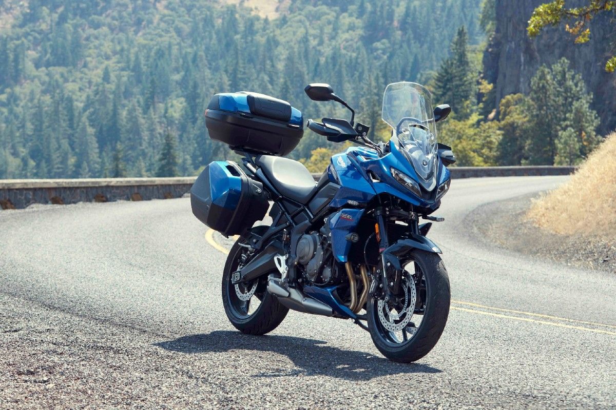 A blue 2022 Triumph Tiger Sport 660 parked on the side of the road.