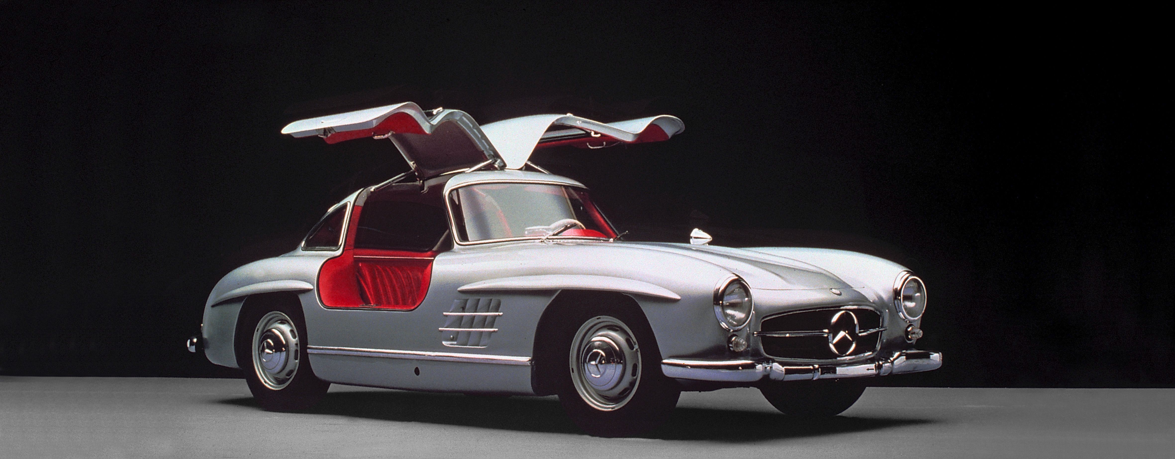 Grey Mercedes-Benz 300SL with Gullwing doors open, front 3/4