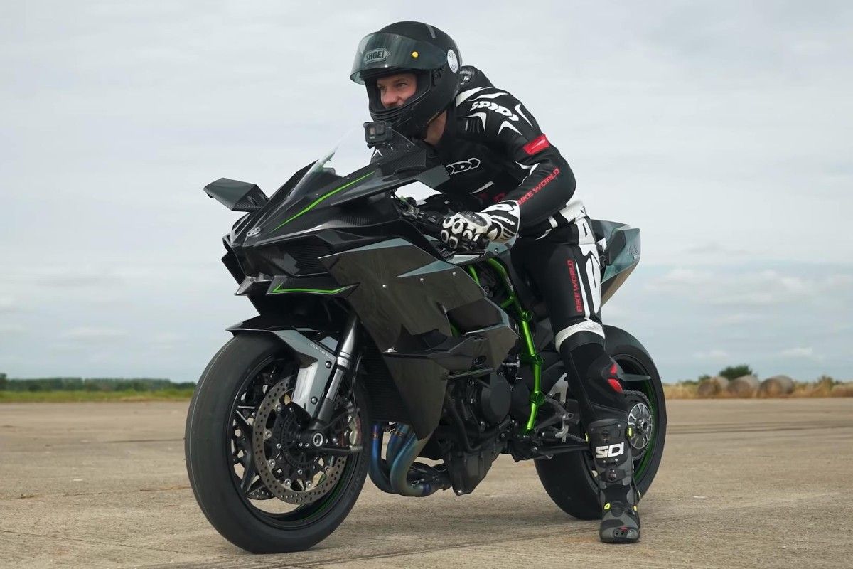 A rider on a Kawasaki Ninja H2R getting ready to ride off.