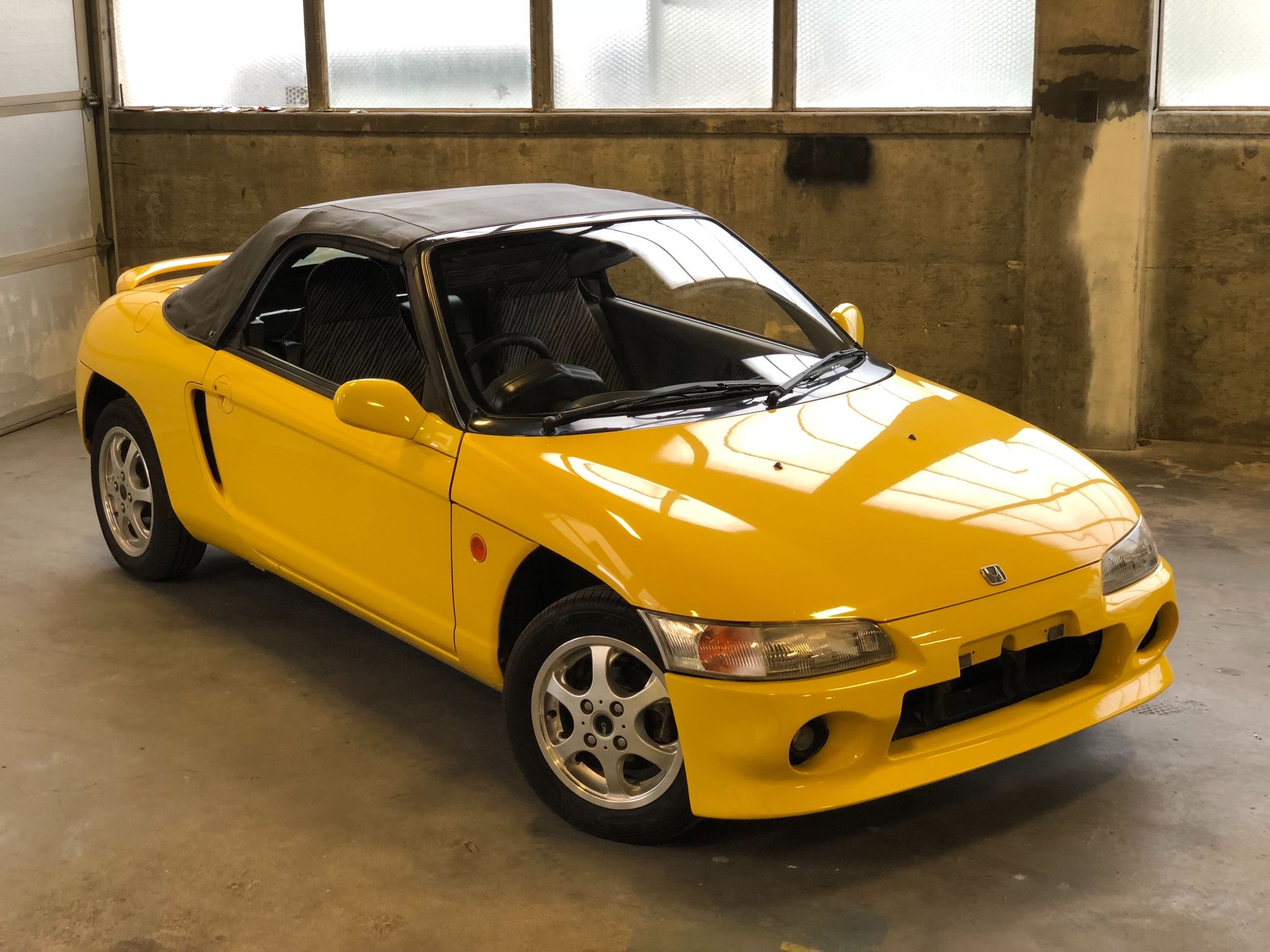 A yellow Honda Beat