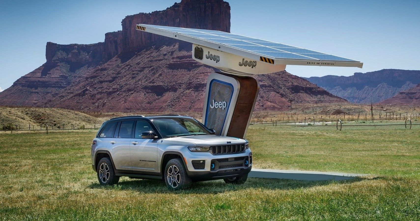 2022 Jeep Grand Cherokee 4xe imagined with a charging station out in the wild