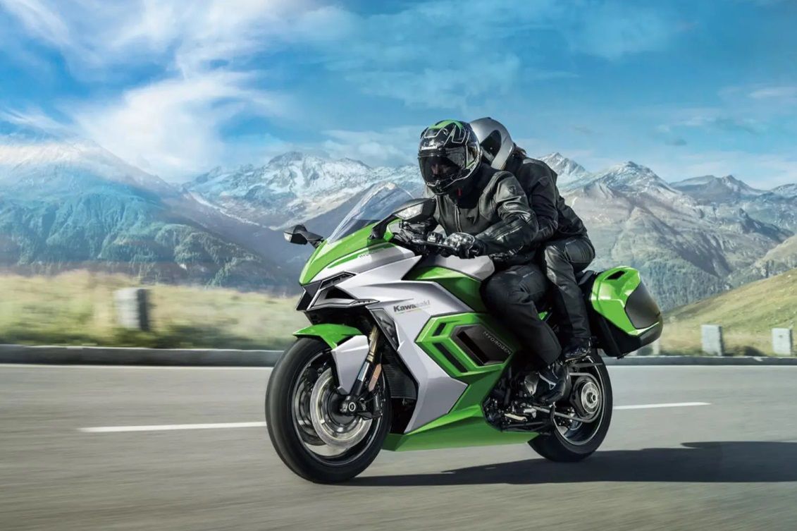Person riding green Kawasaki Hybrid Motorcycle
