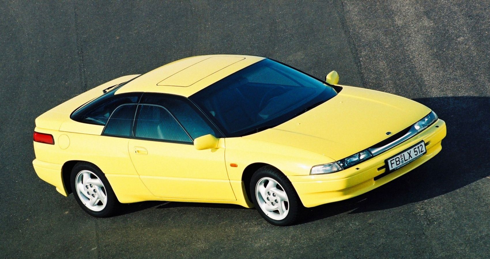 Front 3/4 view of a yellow SVX