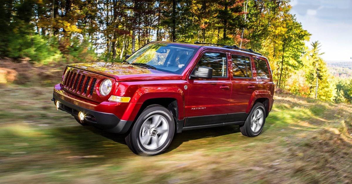 2014 Jeep Patriot SUV driving through the forest