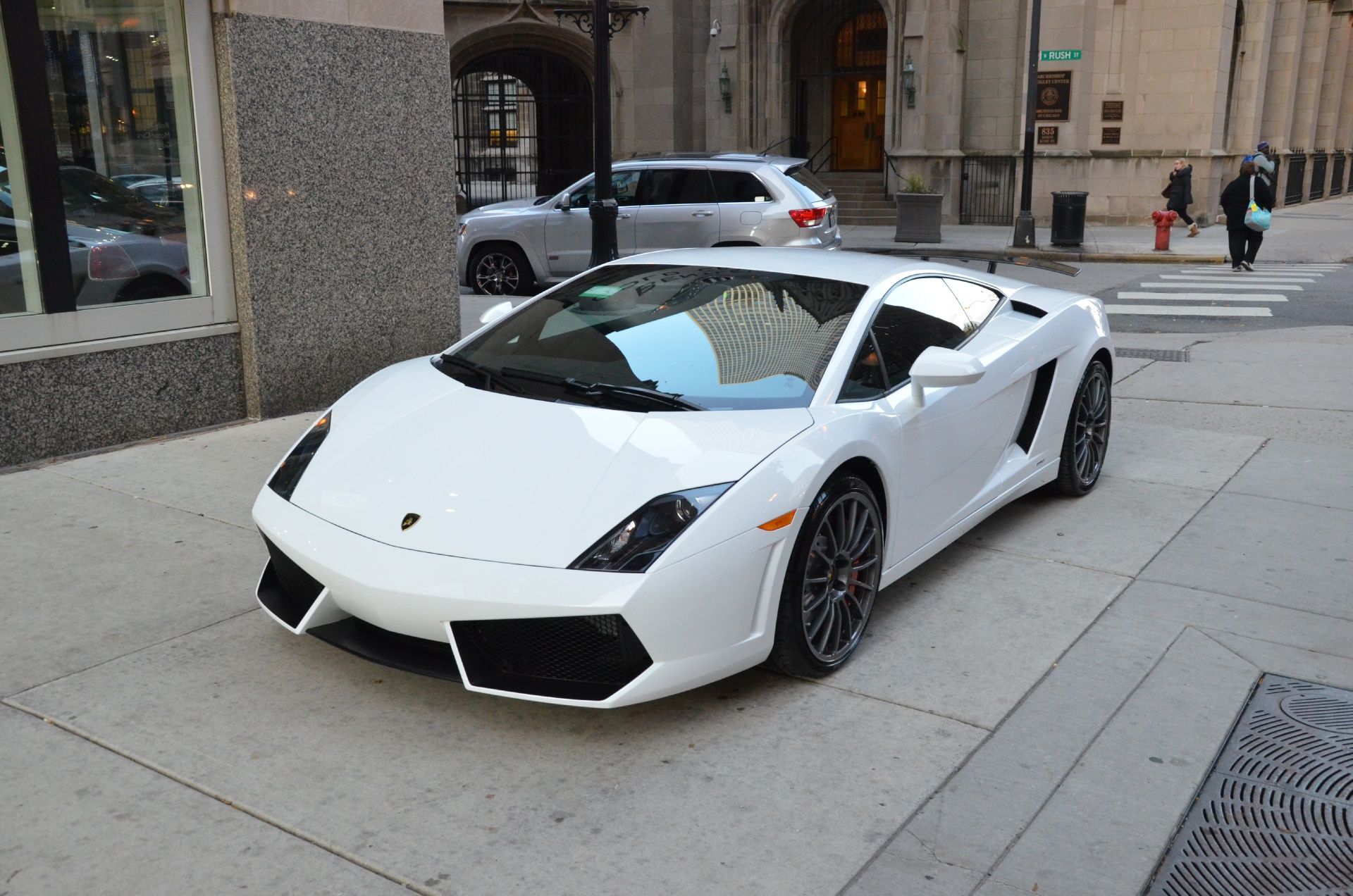 the 2014 Lamborghini Gallardo parked outside a store
