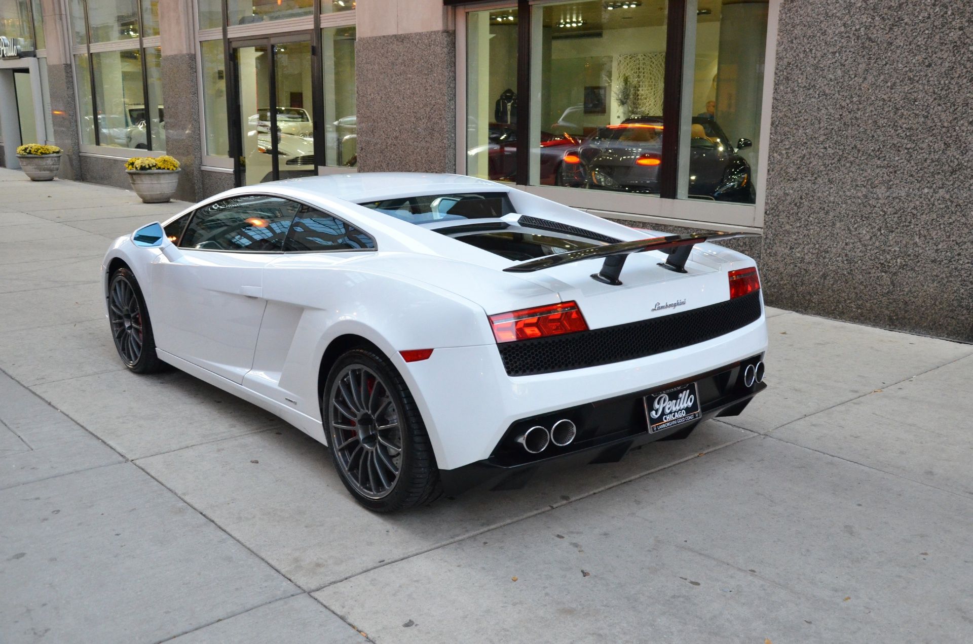 the 2014 Lamborghini Gallardo parked outside a store