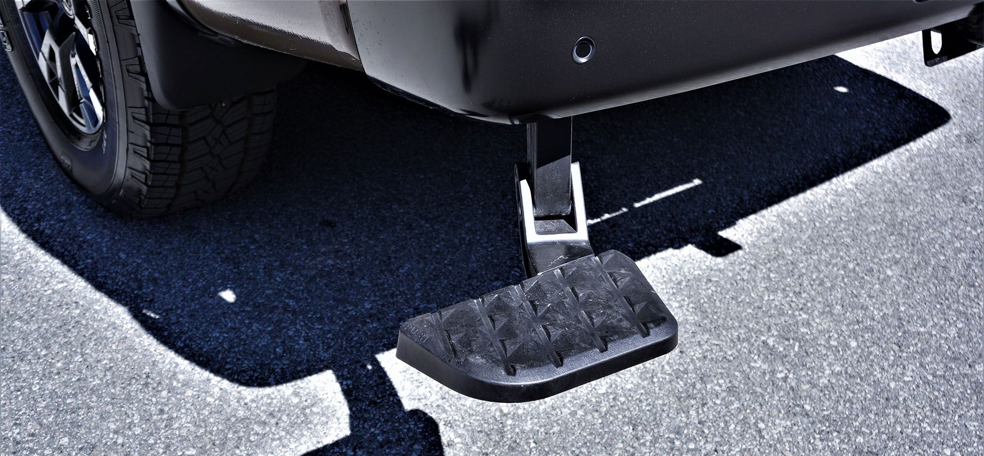 2022 Nissan Titan Crew Cab PRO 4X Luxury showing drop-down step for accessing the bed.