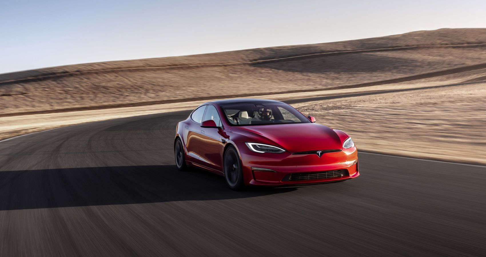 The front of a red Model S Plaid on the move