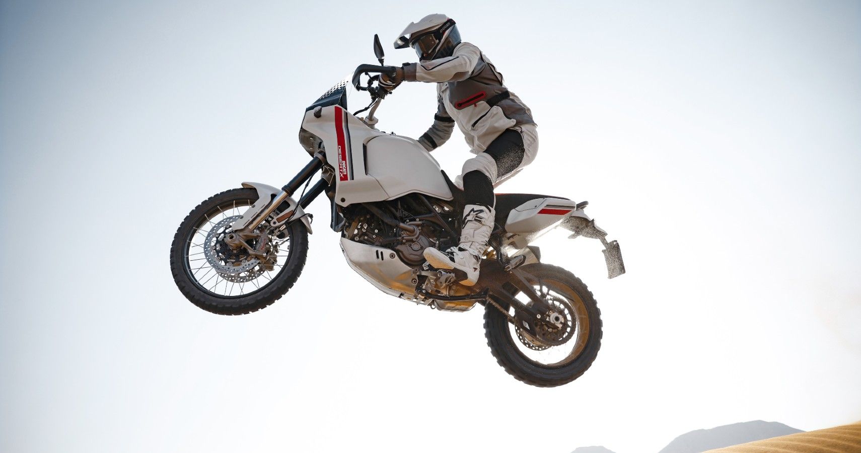 A rider flying through the air on a 2022 Ducati DesertX.