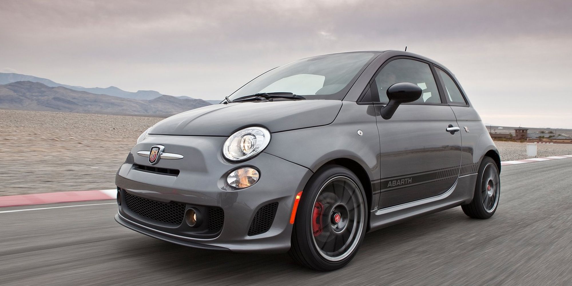 Front 3/4 view of a gray Abarth 500 on track