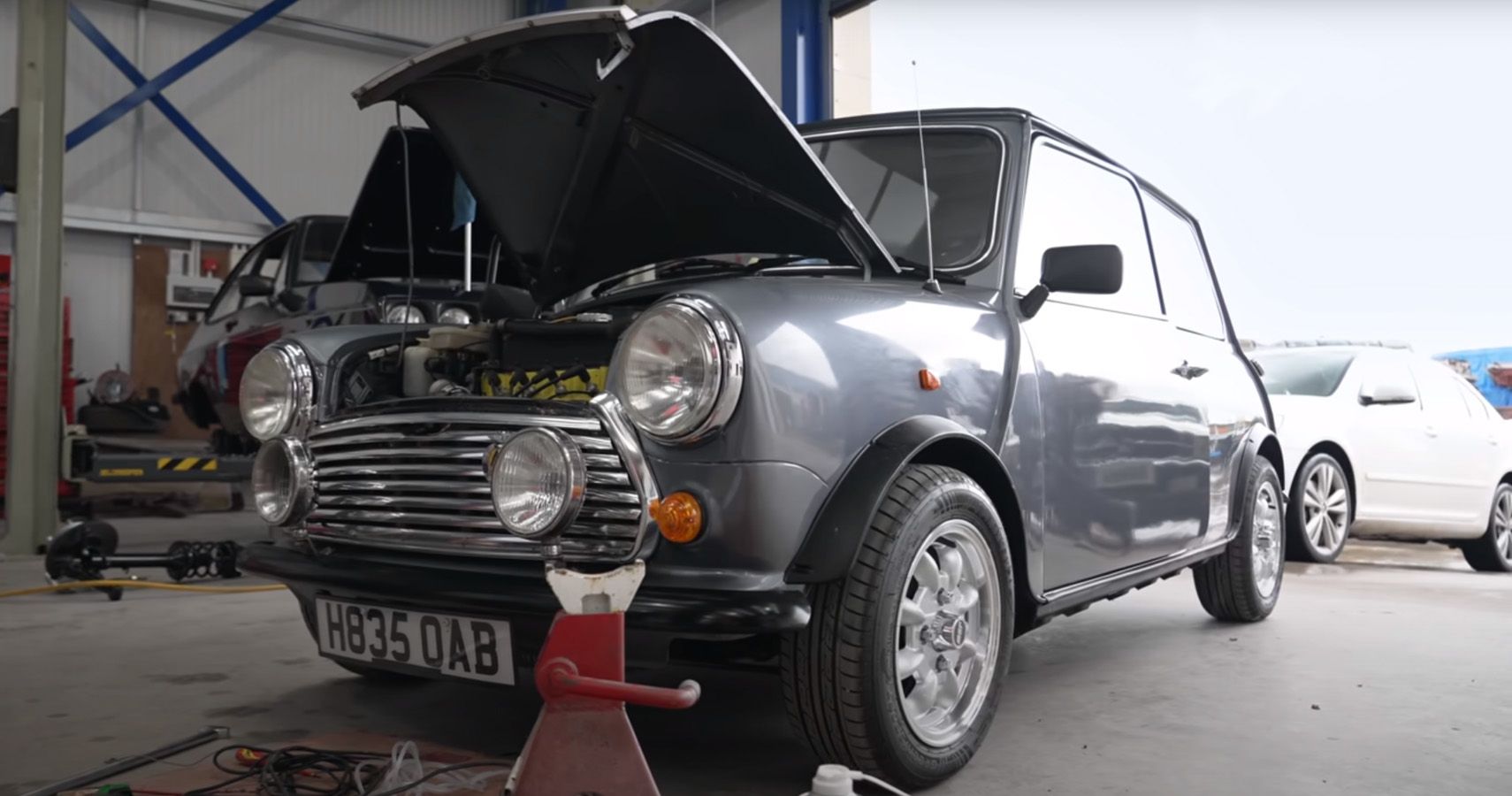 Gray Mini Cooper being repaired in garage