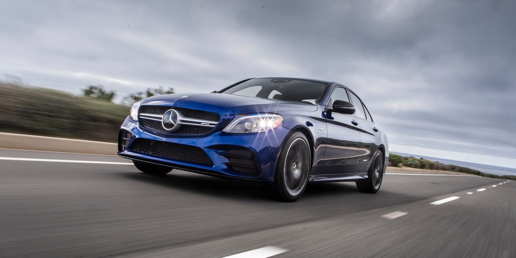 The front of a blue C43 AMG on the move