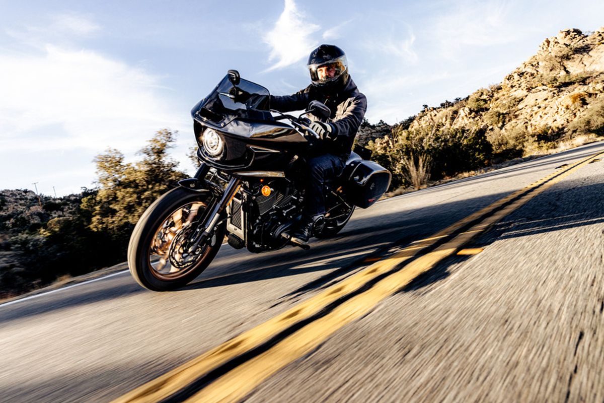 A rider leaning into a corner on a 2022 Harley-Davidson FXLRST Low Rider ST.
