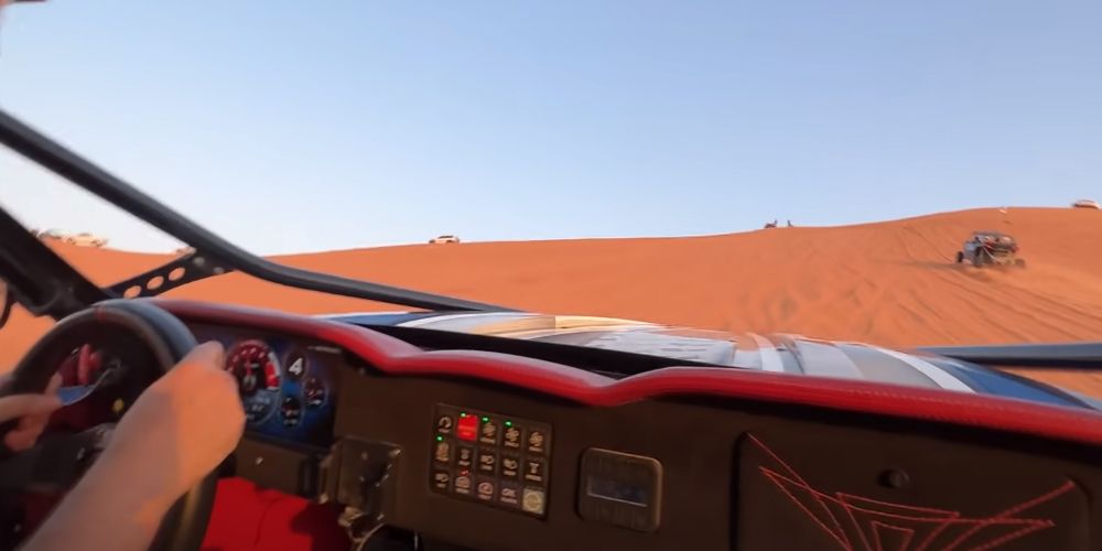 Interior shot of sand buggy climbing dune in Dubai